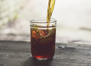 clear glass jar with yellow and red liquid