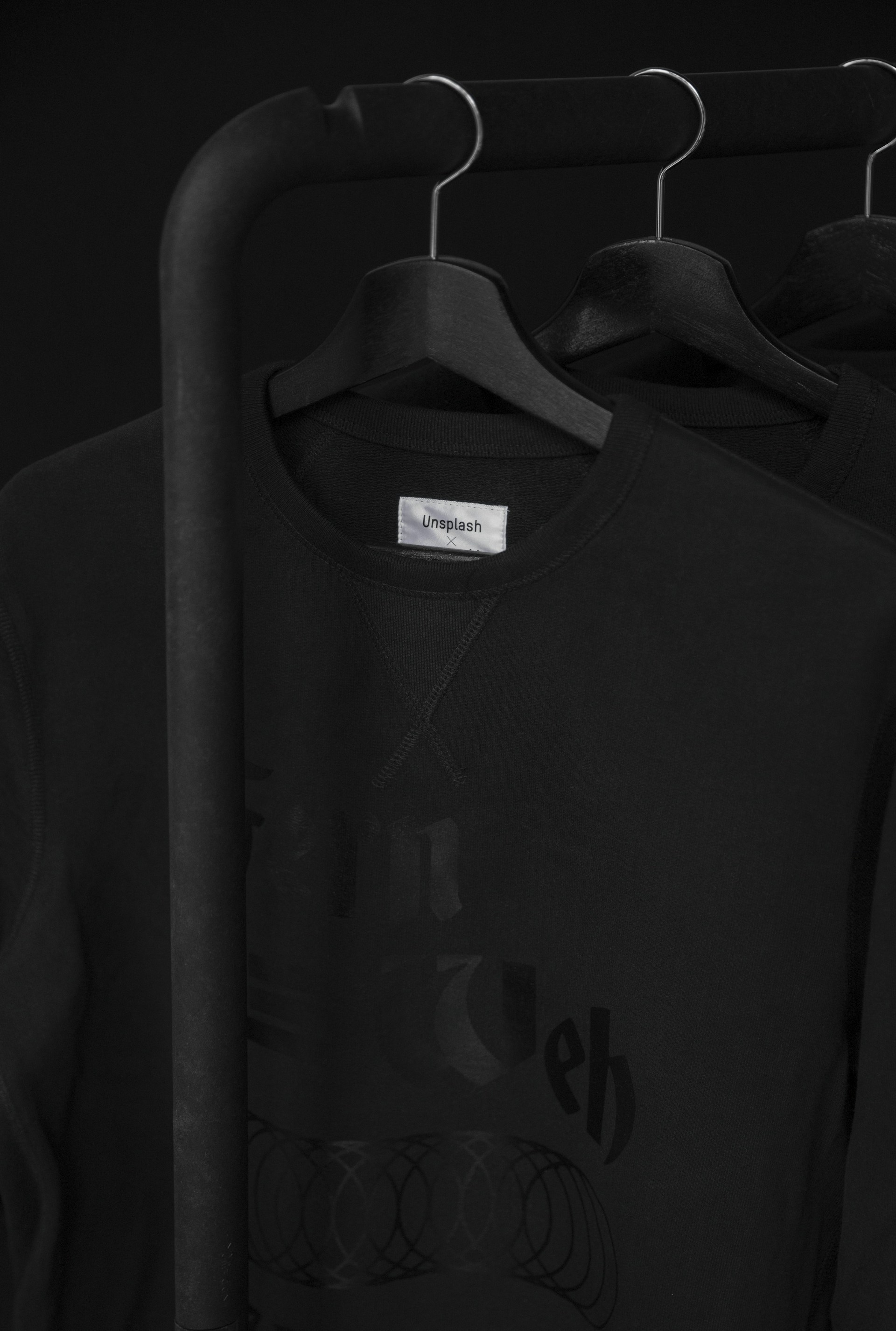 black crew-neck t-shirt on clothes hanger