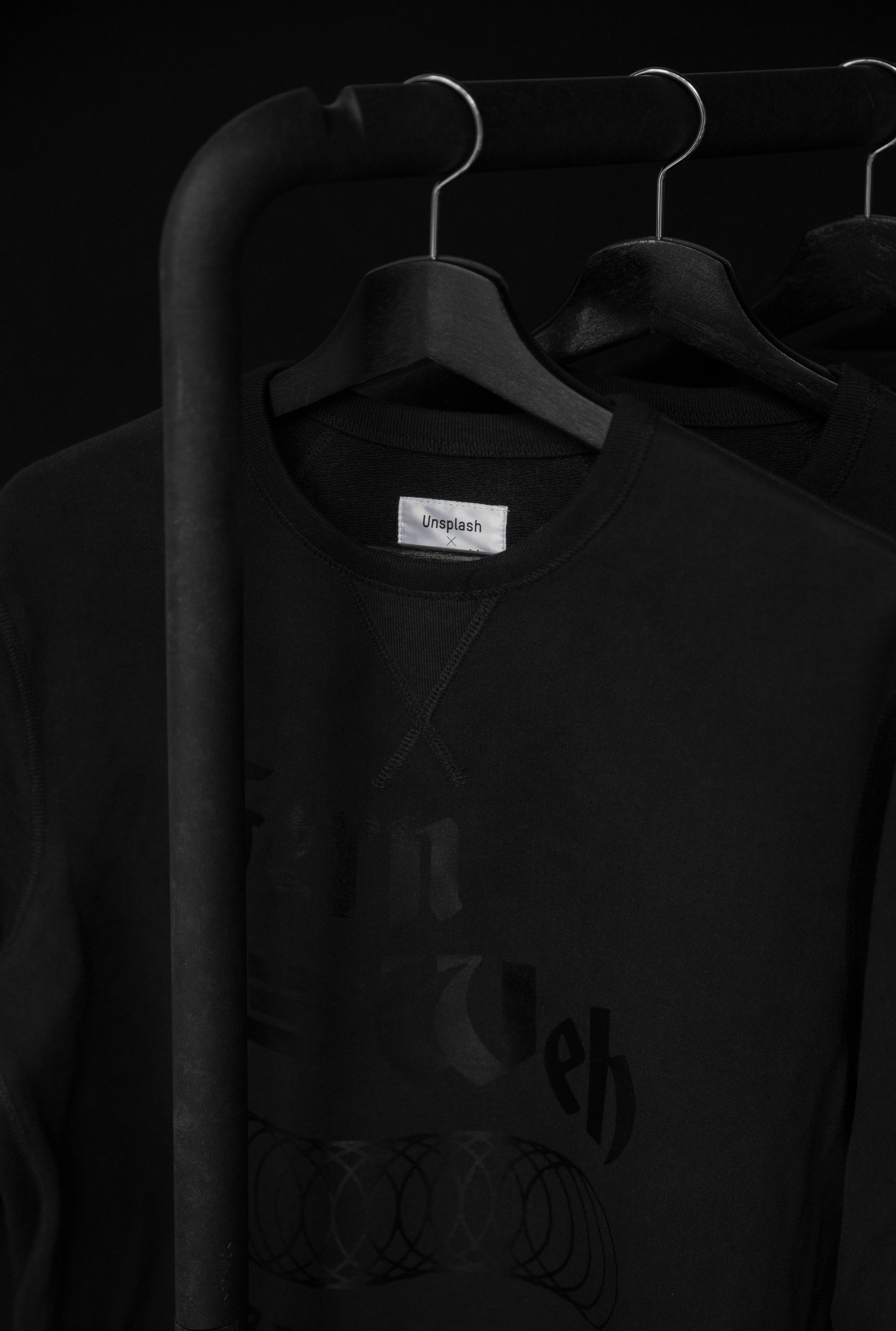 black crew-neck t-shirt on clothes hanger