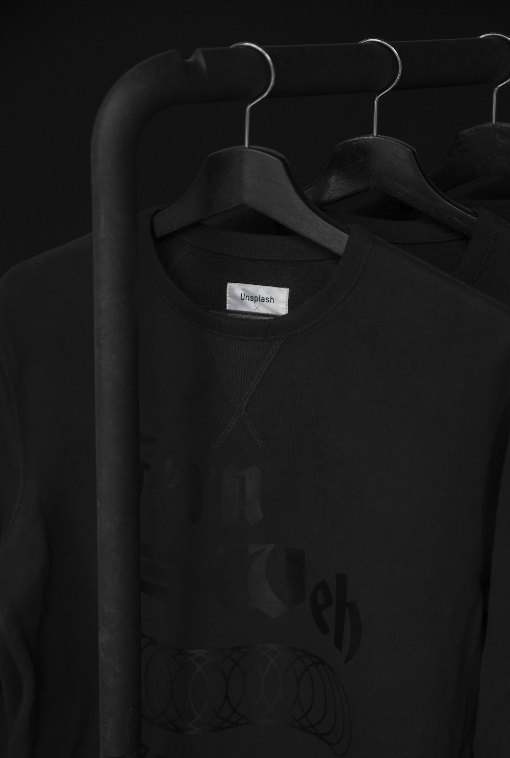 black crew-neck t-shirt on clothes hanger