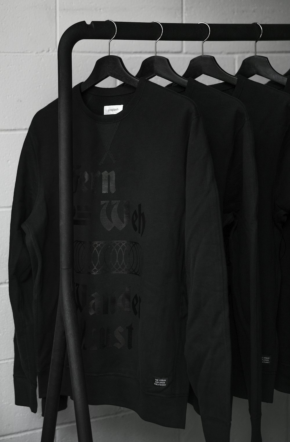 black sweatshirts on plastic hangers