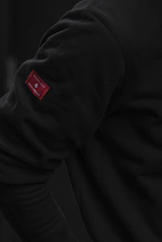 Close-up of a garment's hangtag, label, and RFID chip stitched neatly into fabric.