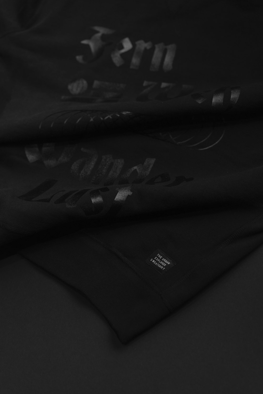 a close up of a black shirt with writing on it