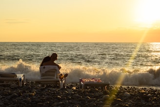 Couple relaxing on a beautiful Mexican beach at sunset.