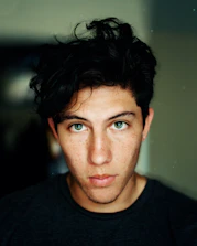 man wearing black crew-neck shirt