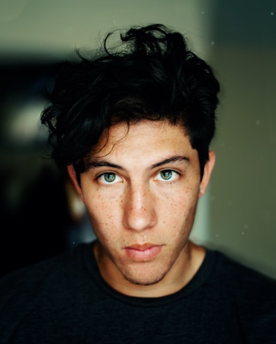 man wearing black crew-neck shirt