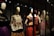 A collection of mannequins adorned with traditional, colorful dresses, featuring elaborate patterns and textiles. Each mannequin has a distinctive hairstyle and pose, creating a sense of cultural heritage and artistic expression.
