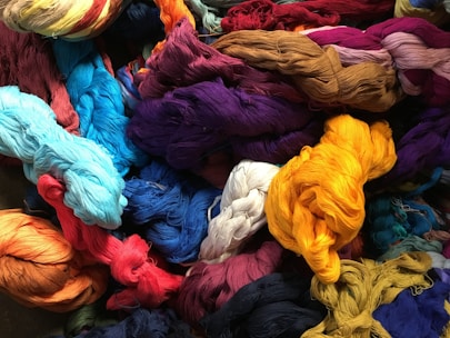 A vibrant display of various acrylic and polyester yarns.