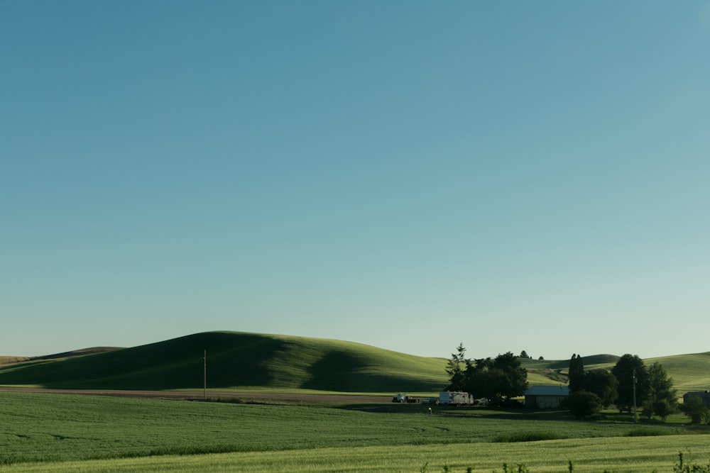 house in the middle of fields and mountains