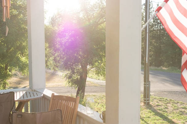 A sunlit group home porch where residents share a joyful morning coffee together.