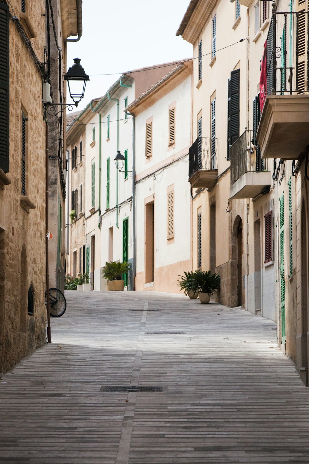 straight alley road with brown buildings