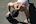 An athlete performing strength exercises outdoors with a physical therapist coaching nearby.