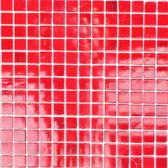 A grid of square tiles in various shades of red with some tiles exhibiting a glossy finish and light reflections. The arrangement of the tiles is somewhat irregular with a noticeable pattern disruption in some areas.