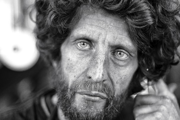 A candid black-and-white portrait capturing a weathered face full of stories.