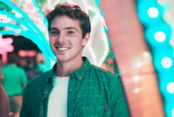 selective focus bokeh photography of man with broad smile