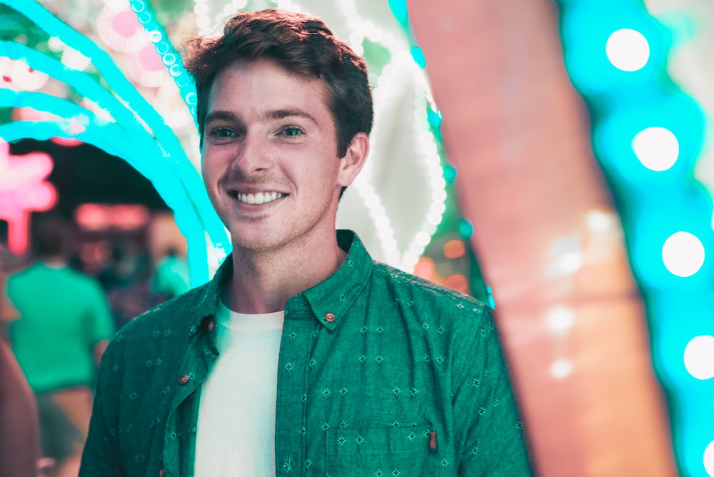 selective focus bokeh photography of man with broad smile