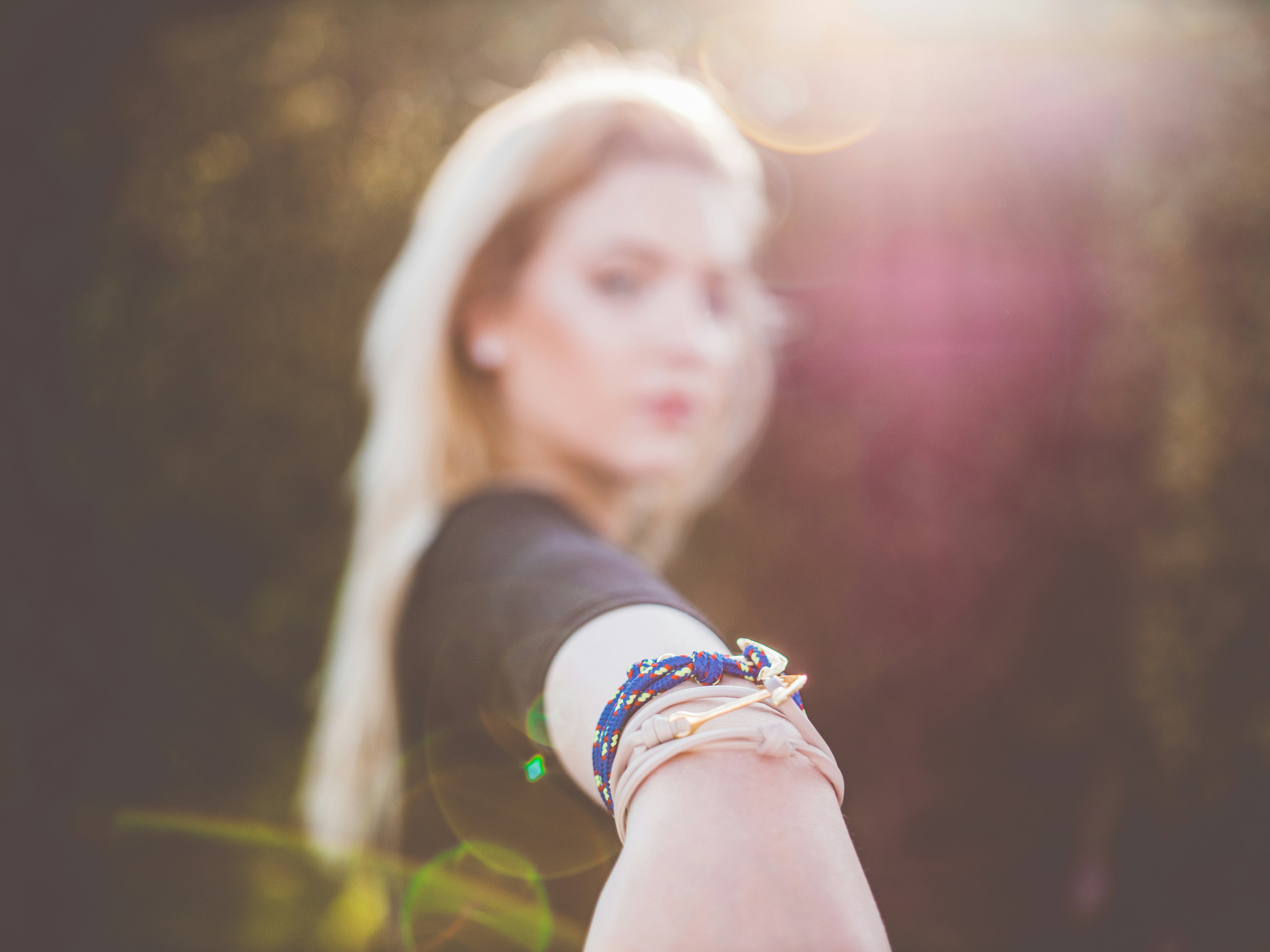 woman wearing blue and beige bracelets