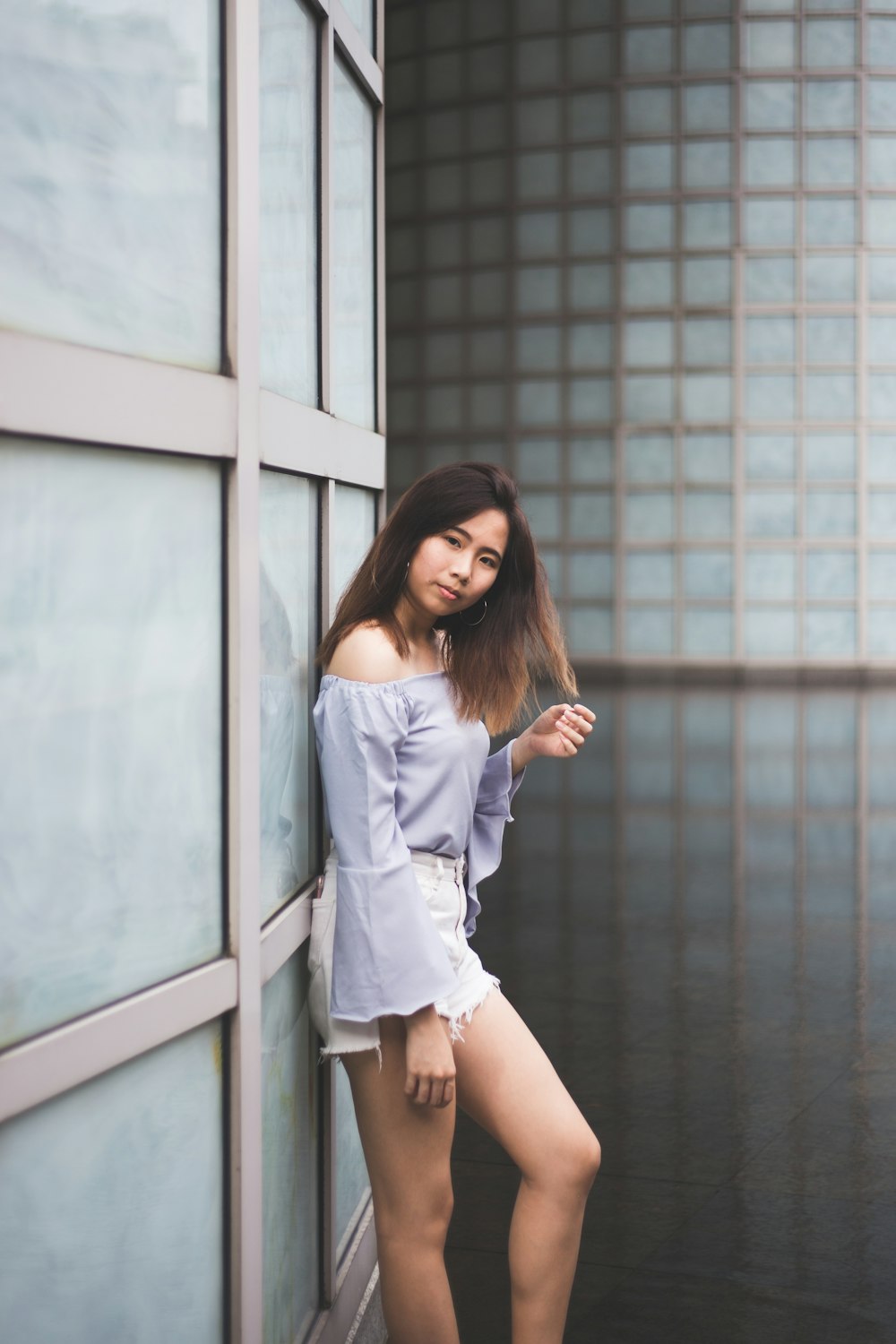 woman standing beside wall