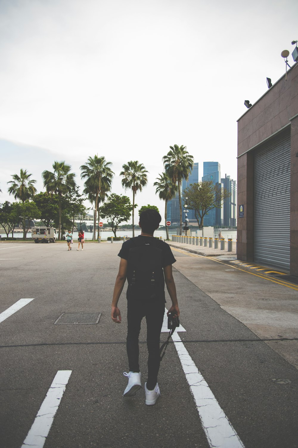 man in black t-shirt on gray concrete road