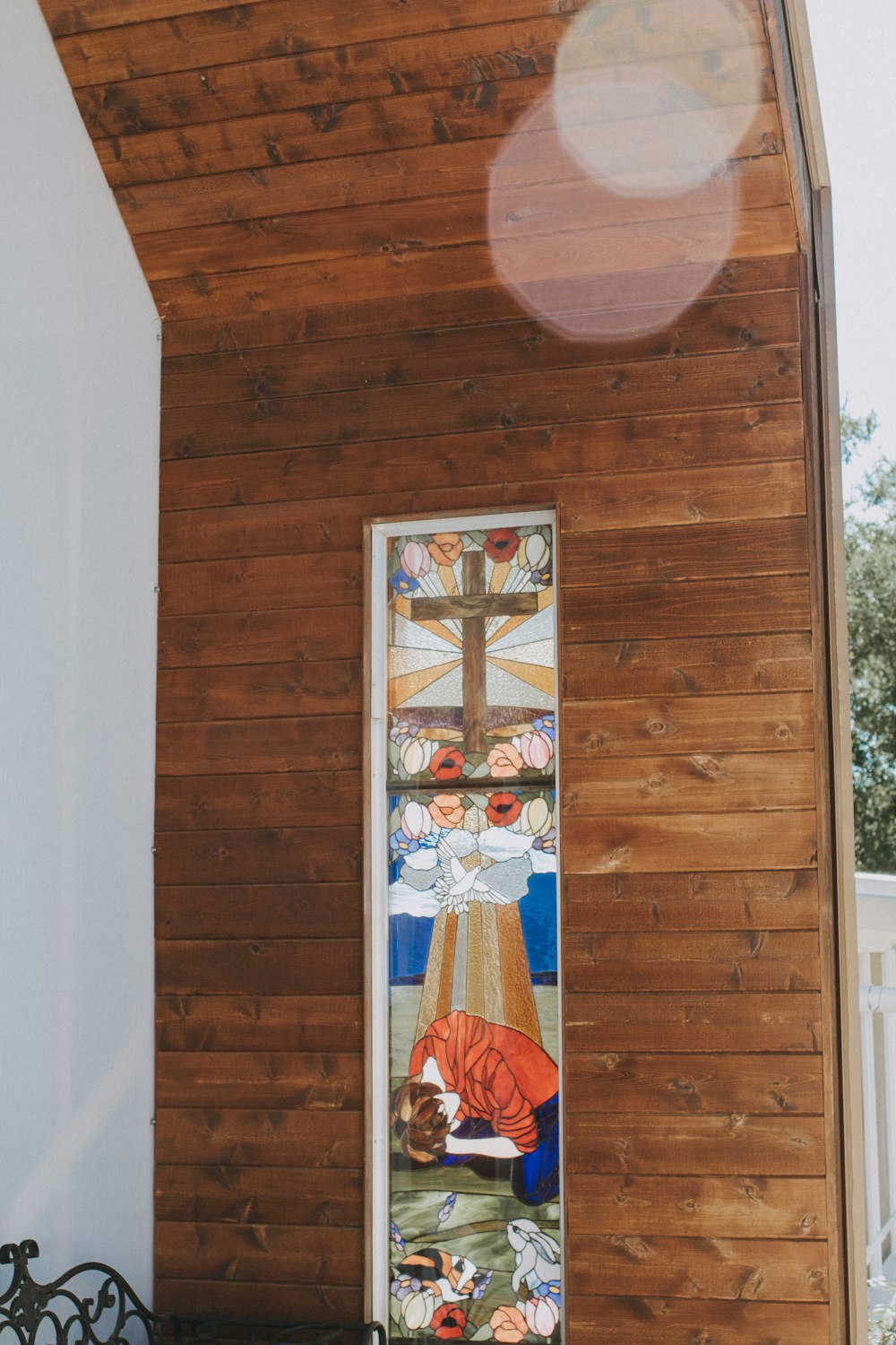 a stained glass window in the side of a building