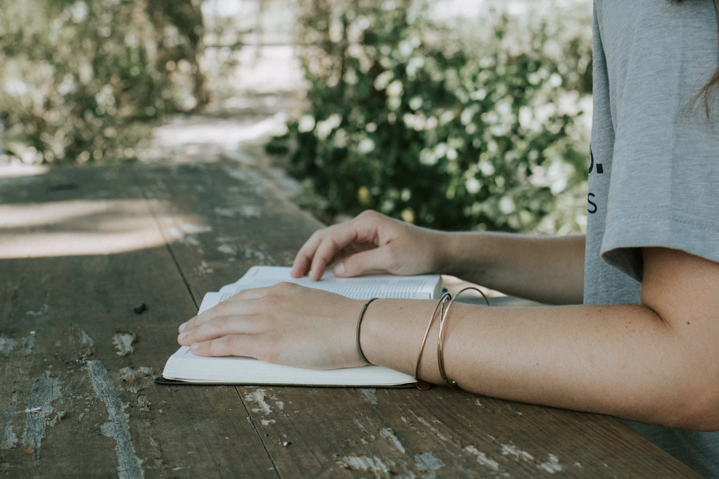 Person reading a book at a desk