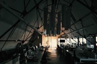Technician installing a suspended ceiling grid in a modern office space