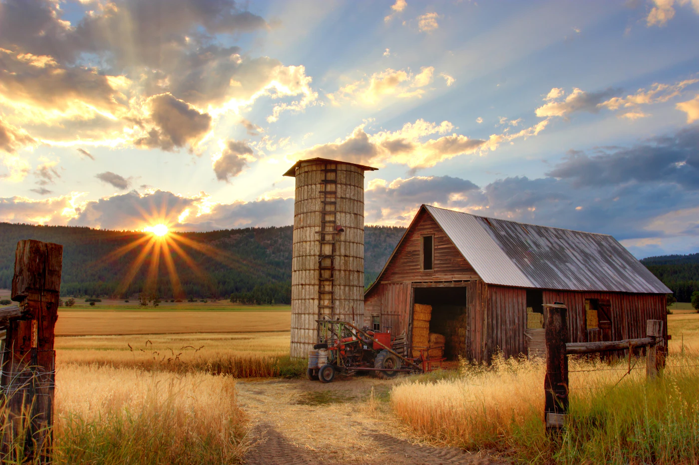 A weathered wooden barn at sunset on the ranch