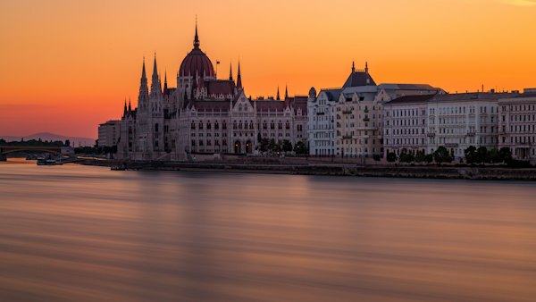 White and red concrete building near body of water — Budapest, Hungary