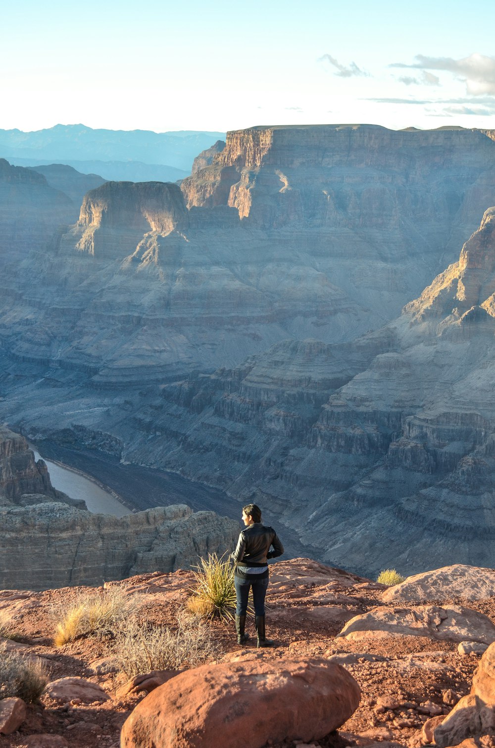 woman standing on rock mountain during day time