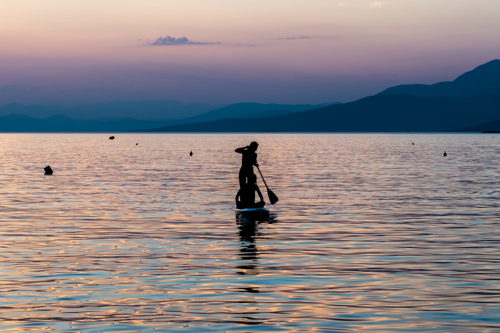 silhouette of person riding on boat