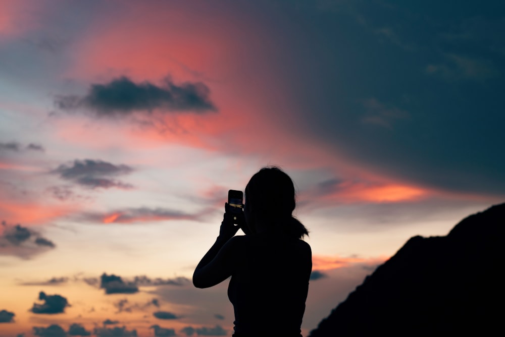 silhouette of person holding phone