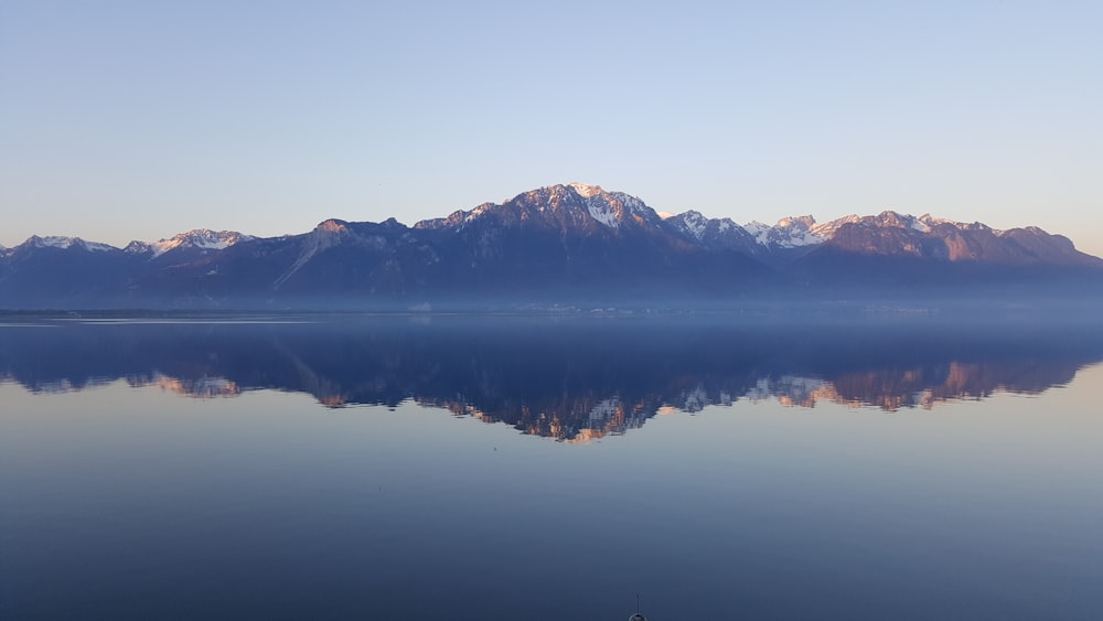 rock mountains near sea at daytime