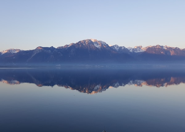 rock mountains near sea at daytime