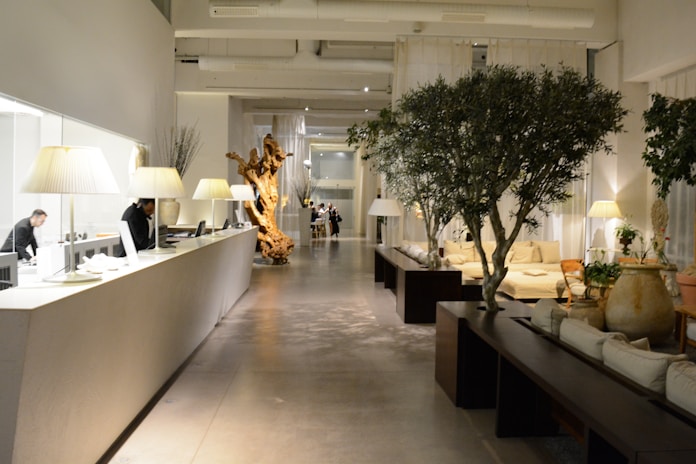 Elegant clinic reception area with soft beige tones and minimalist design.