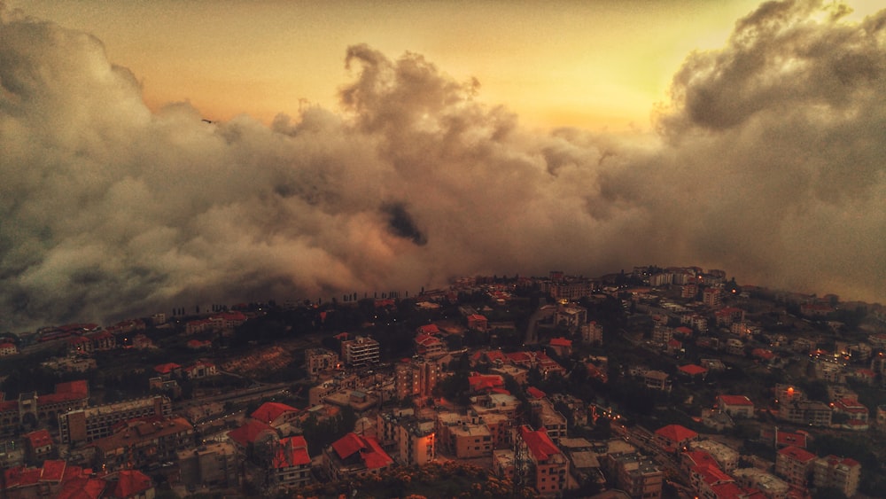 aerial photo of city covered with clouds