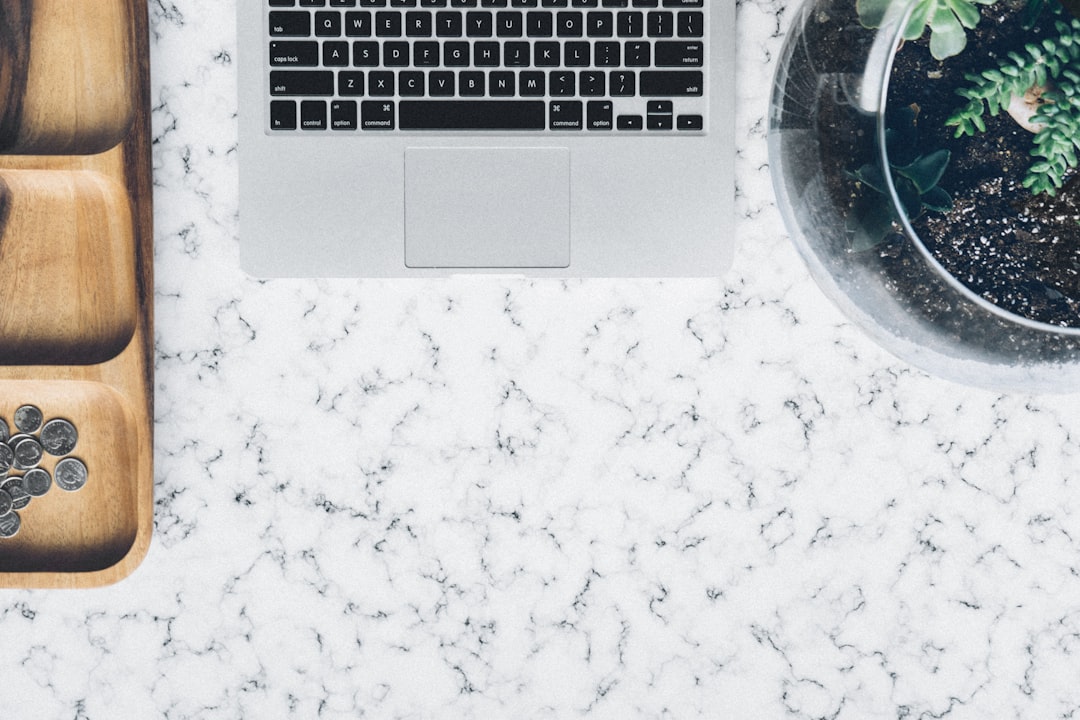 silver MacBook in between jar and tray