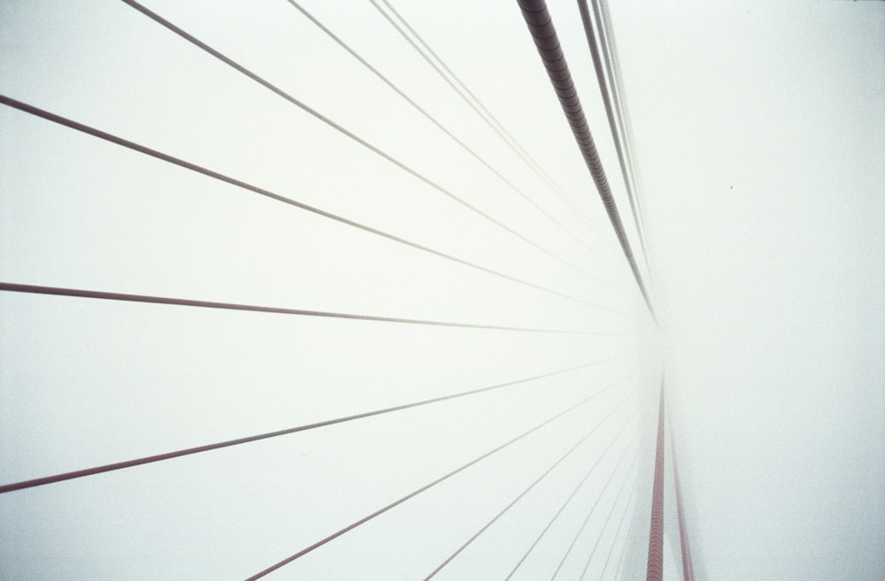 a close up of a very tall bridge in the fog