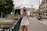 man holding DSLR camera beside bridge
