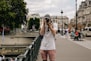 man holding DSLR camera beside bridge