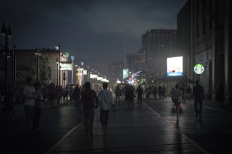 People walking along CyberHub’s illuminated pathways, showcasing its vibrant nightlife.