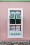opened white teal and brown wooden louvered window panel