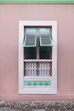 opened white teal and brown wooden louvered window panel