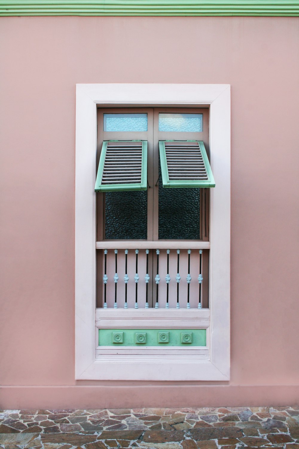 opened white teal and brown wooden louvered window panel