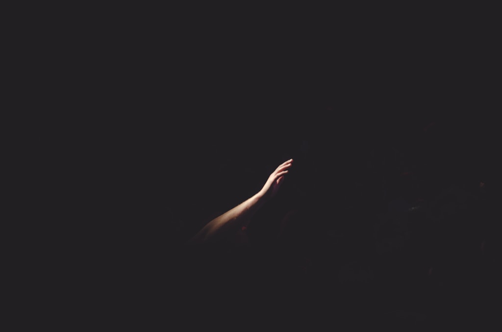 Human hand in darkness