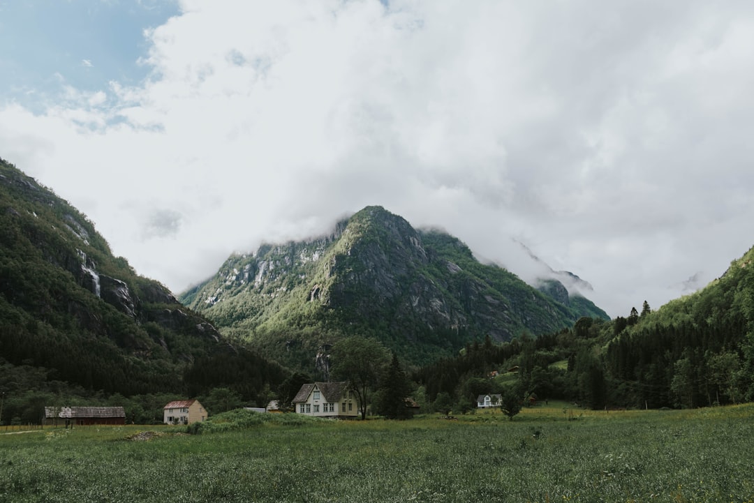 green mountains under cloudy sky