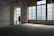 A woman in a floral dress stands near a large window in an empty, dimly lit room with tiled floors. The space features industrial-style architecture and large glass-paneled doors that allow light to filter in, casting a soft glow. A 'descida' sign indicates an exit, adding to the ambiance of solitude.