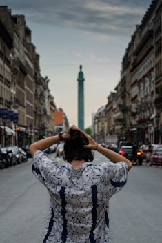 back view of man wearing floral top while fixing his hair