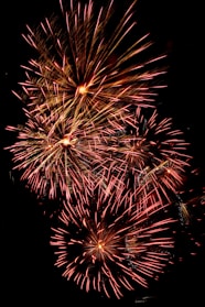 A fiery burst of red and gold fire shots lighting up the sky.