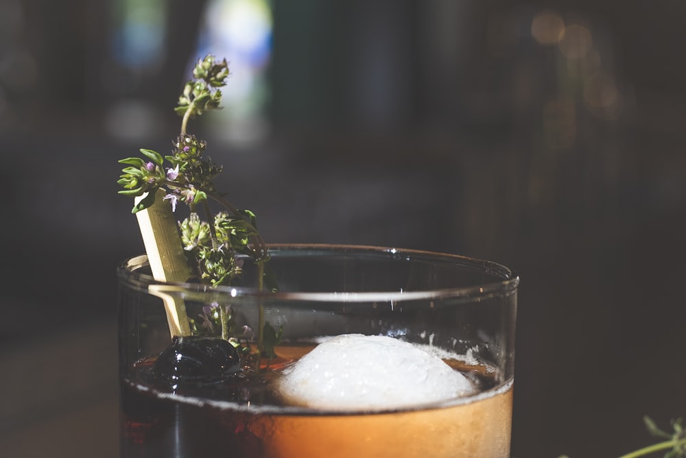 closeup photo of clear wine glass with brown liquid