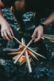 person holding gray wooden wood